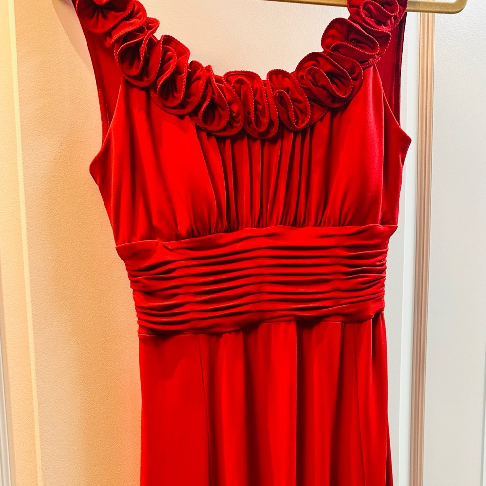 Beautiful red dress with flower pattern on neck .